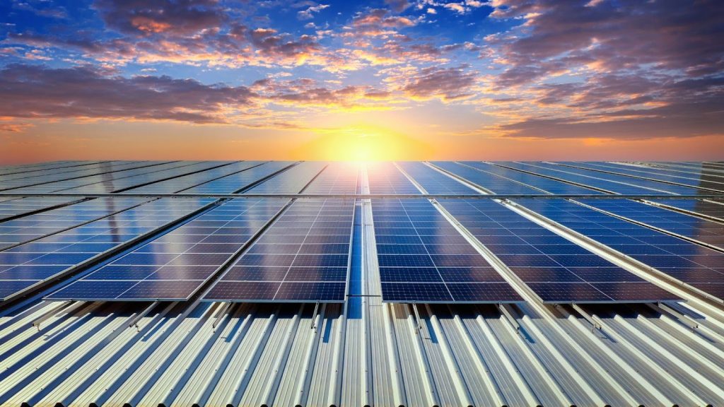 Solar panels in a line low angle with sun in the middle